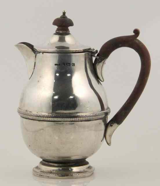 Appraisal: A silver hot water jug Birmingham with ribbed border and