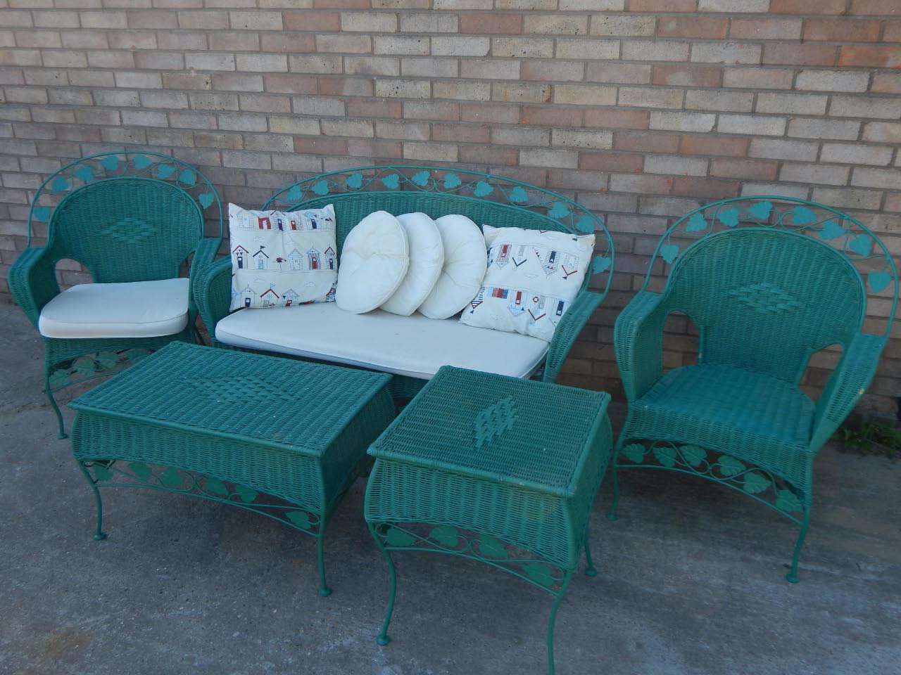 Appraisal: A metal patio suite comprising two seater settee footstool and