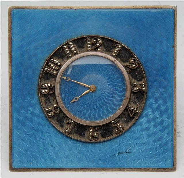 Appraisal: A BLUE ENAMEL AND SILVER DESK CLOCK marked 'Swiss' square