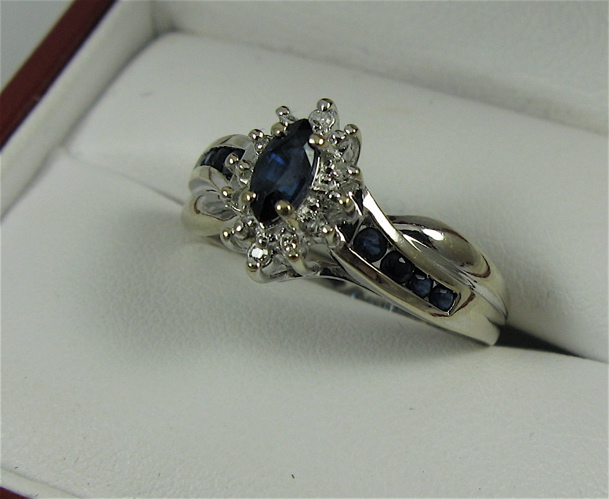 Appraisal: SAPPHIRE DIAMOND AND K GOLD RING centering a marquise-cut blue