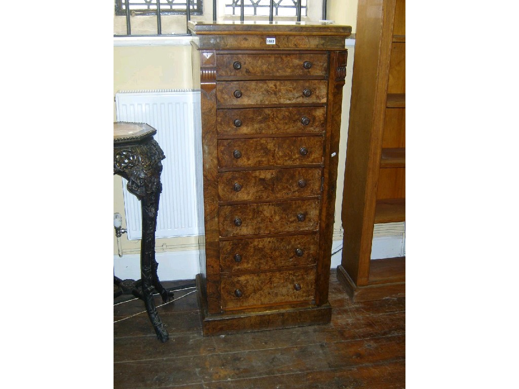 Appraisal: A Victorian walnut and figured walnut Wellington chest fitted with