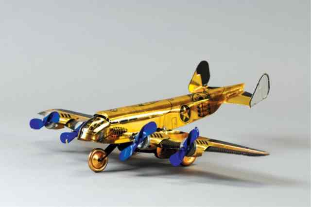 Appraisal: MARX BOMBER PLANE Lithographed tin done in interesting gold finish