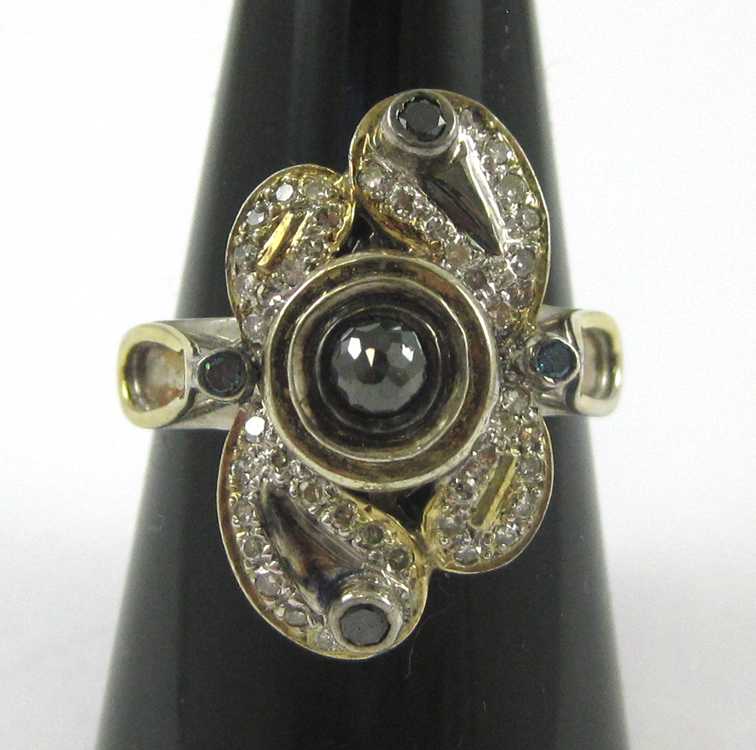 Appraisal: DIAMOND SILVER AND YELLOW GOLD RING The sterling silver and