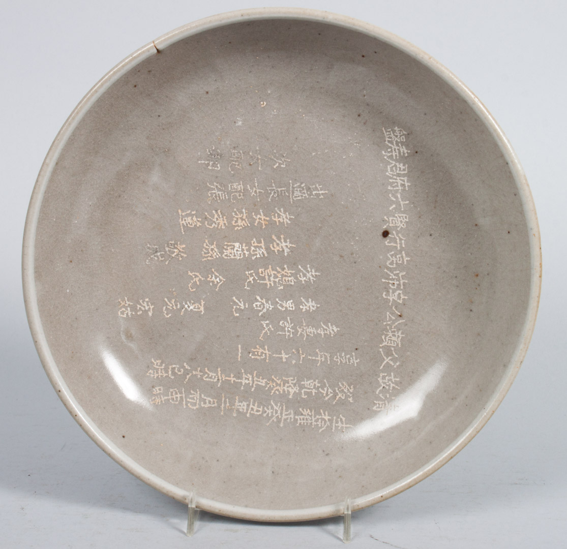 Appraisal: Chinese grey ware bowl with calligraphy decoration low bowl with