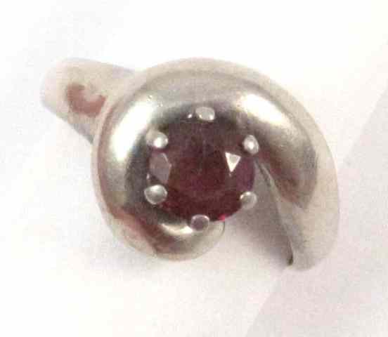 Appraisal: GARNET AND FOURTEEN KARAT WHITE GOLD RING set with a