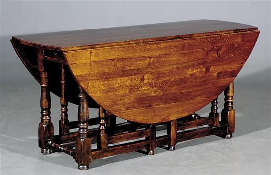 Appraisal: English oak harvest table early th centuryoval top with drop