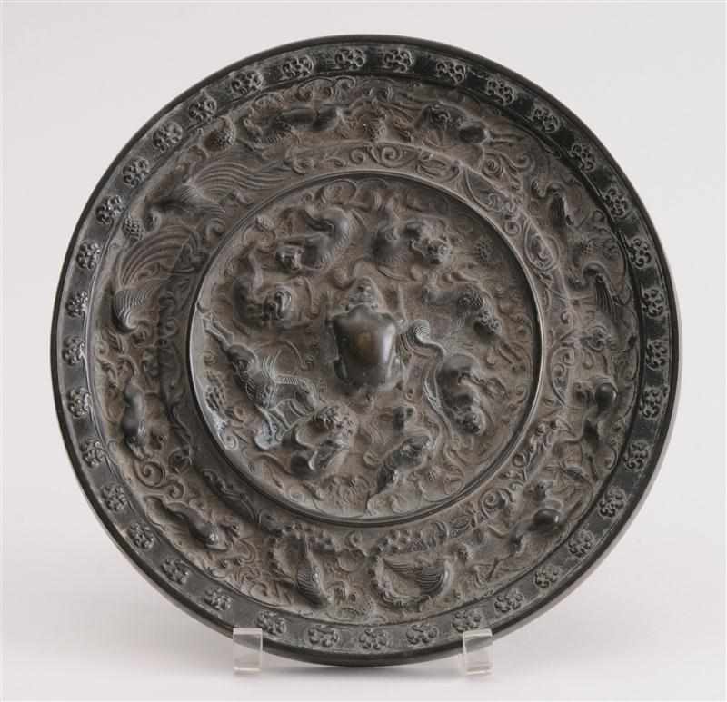 Appraisal: TANG STYLE BRONZE MIRROR Centered by a crouching beast encircled