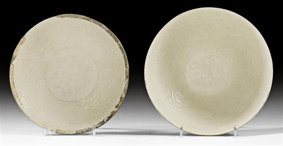 Appraisal: TWO CREAMY GLAZED QINGBAI BOWLS WITH MOULDED PHOENIX DESIGN China