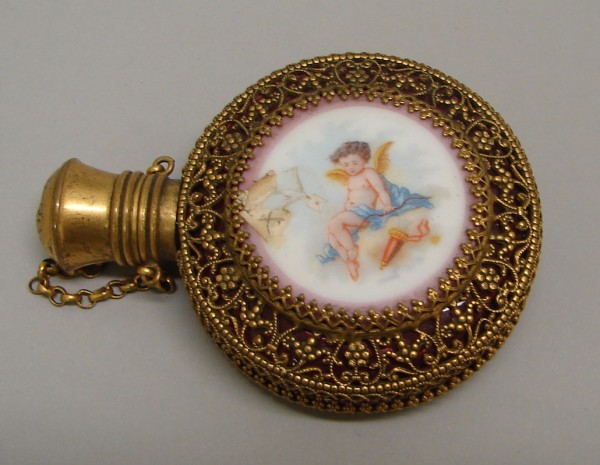 Appraisal: Perfume vial features cranberry glass with porcelain central medallion featuring