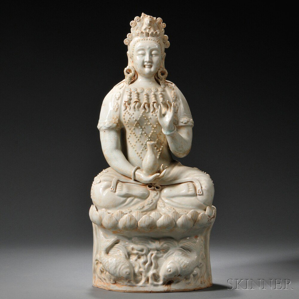 Appraisal: Qingbai-glazed Figure of Guanyin China th century depicted seated on