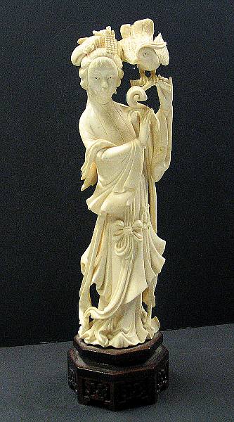 Appraisal: An ivory carving of a beauty holding a Mandarin duck