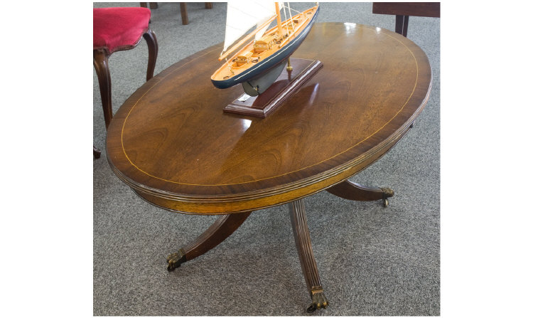 Appraisal: Oval Mahogany Coffee Table on sprayed and reeded legs casters