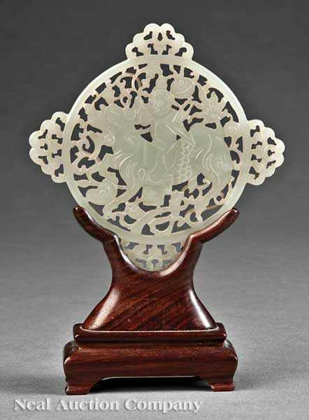 Appraisal: A Chinese Archaistic White Jade Reticulated Plaque the circular center