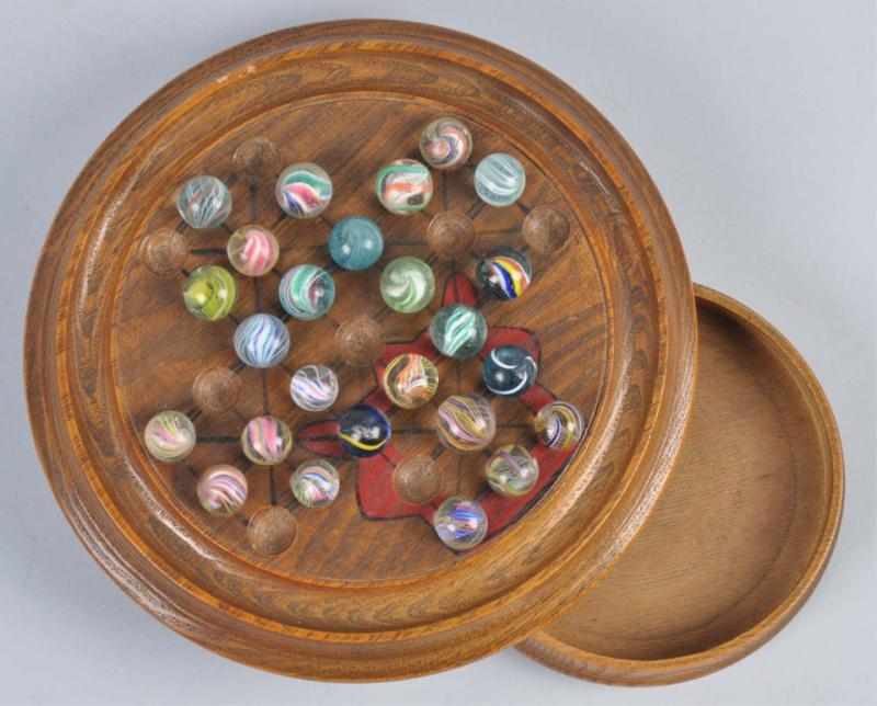 Appraisal: Solitaire Board Marbles Description Early marble game board with red