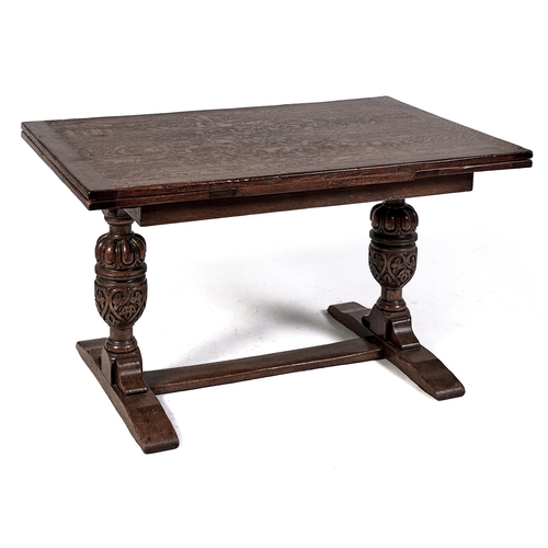 Appraisal: An oak draw leaf dining table c on carved cup-and-cover