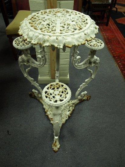 Appraisal: A pierced cast iron plant stand with central circular tier