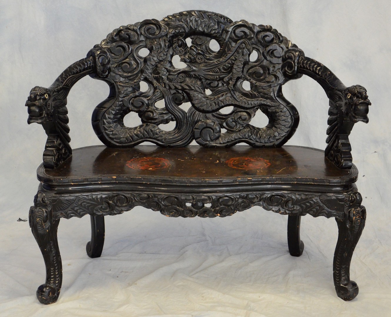 Appraisal: Asian black lacquer and dragon carved bench with painted dragons