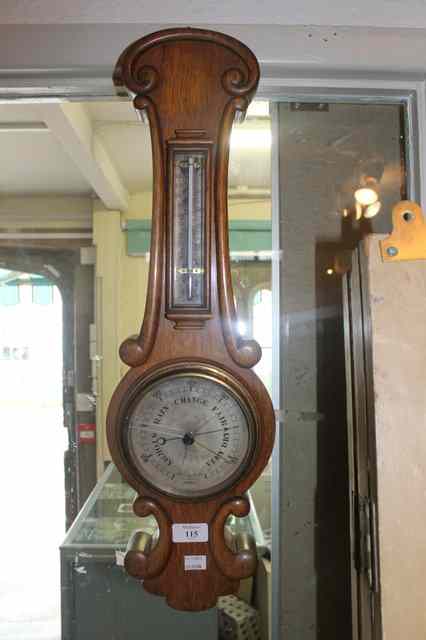 Appraisal: A VICTORIAN OAK BAROMETER of shaped form with thermometer attached