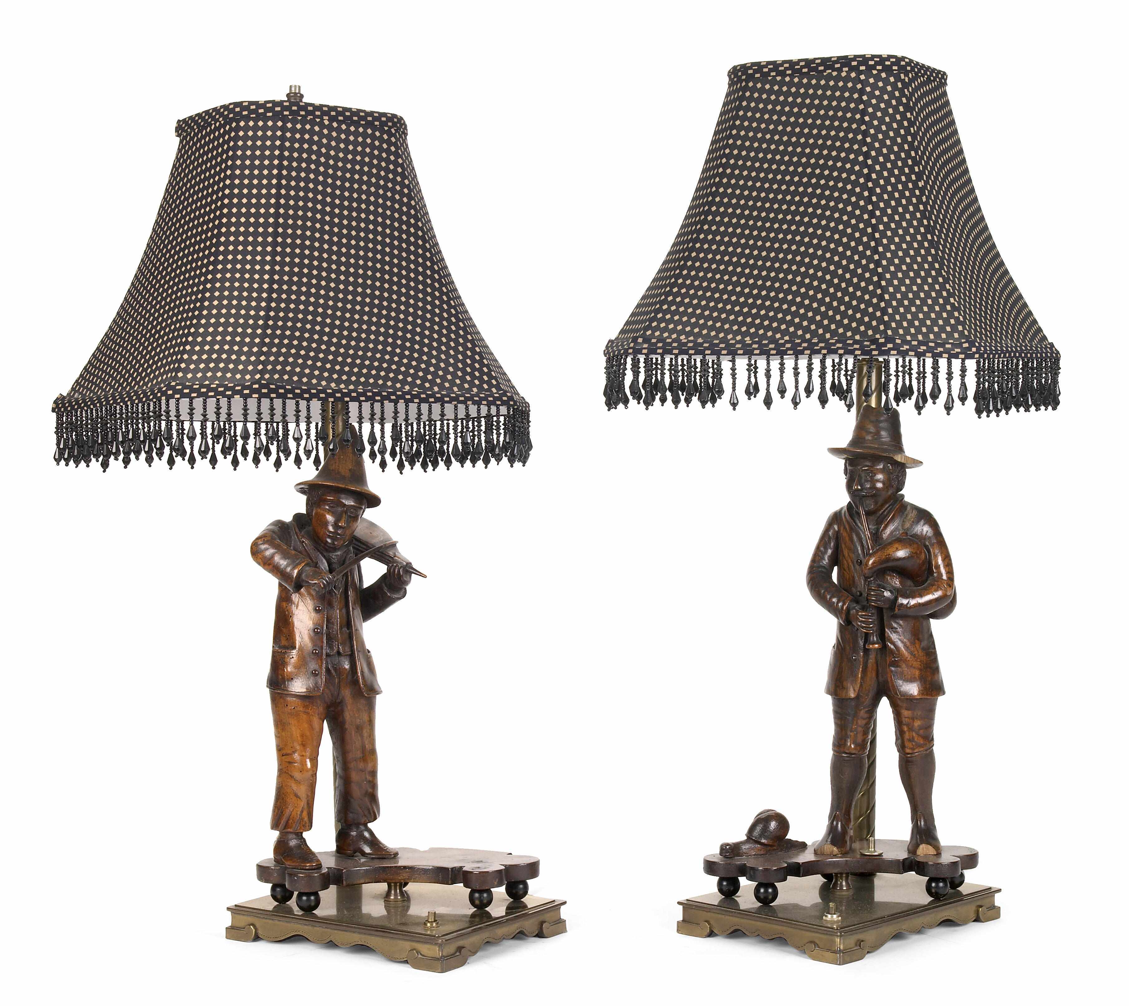 Appraisal: A pair of wood and brass musical figure table lamps