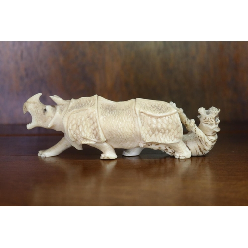 Appraisal: Carved bone figure of a tiger and rhinoceros in combat