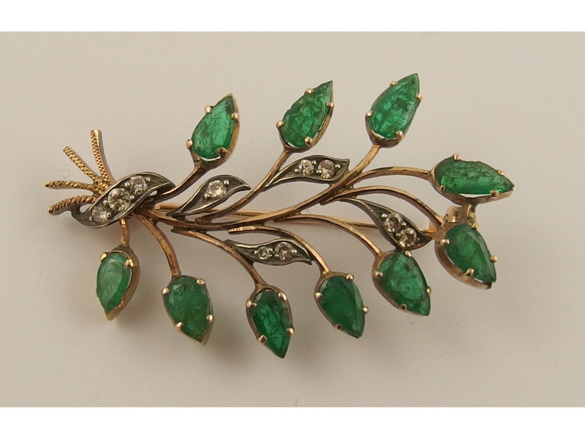 Appraisal: An emerald and diamond floral broochthe ten marquis shaped emeralds