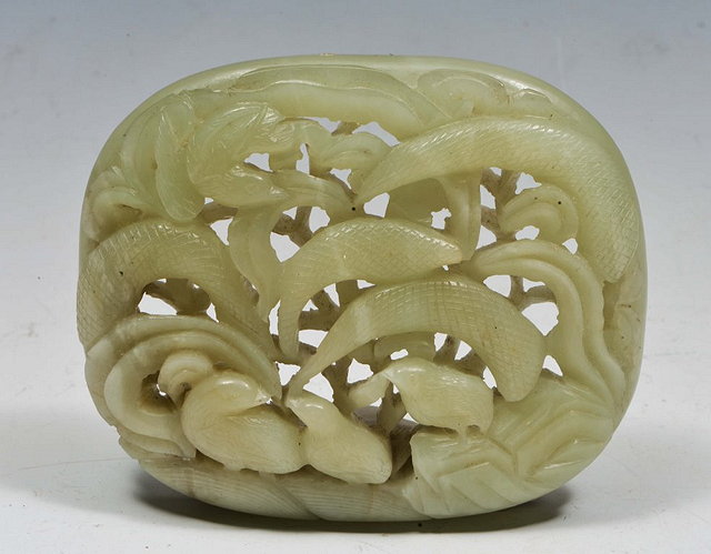 Appraisal: A CHINESE CARVED JADE OVAL PANEL with ducks and leaves