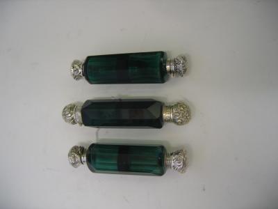 Appraisal: THREE VICTORIAN DOUBLE ENDED SCENT BOTTLES the panelled green glass