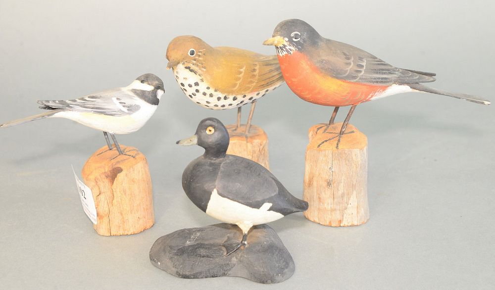 Appraisal: Group of four carved birds on wooden stands three signed