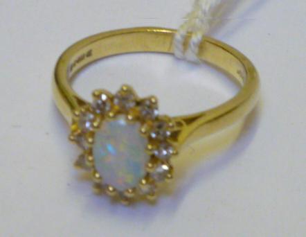 Appraisal: AN OPAL AND DIAMOND RING the oval cabochon opal claw