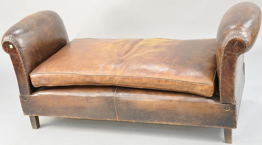 Appraisal: Brown leather daybed arms drop one seam split in cushions