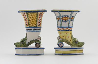 Appraisal: Two French fa ence cornucopia vases the horns issuing from