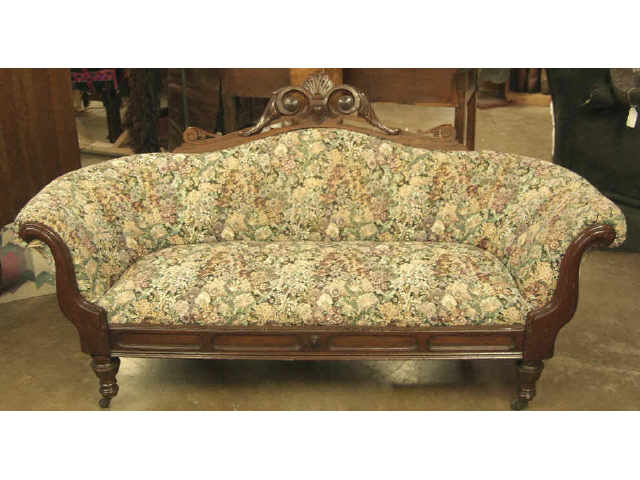 Appraisal: Walnut tapestry upholstered settee on castors with carved upper crest