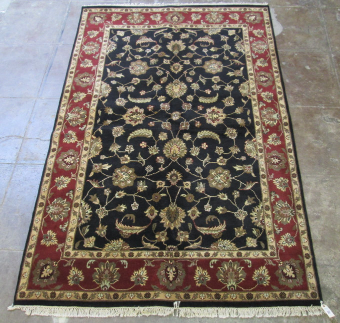 Appraisal: ORIENTAL INDO-PERSIAN CARPET Persian Isfahan floral design on black field