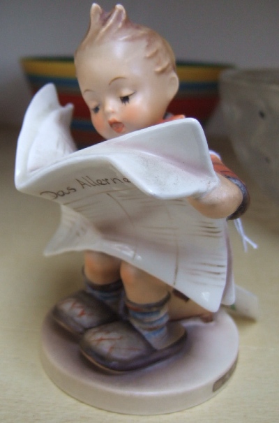 Appraisal: A Hummel figure of a seated boy reading a newspaper