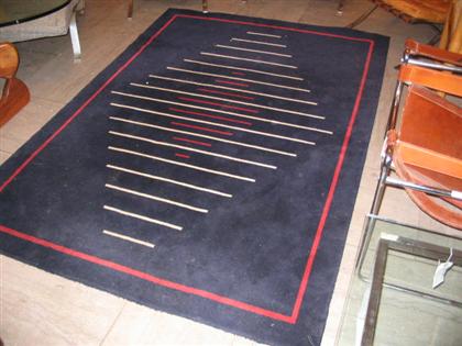 Appraisal: Contemporary black red and white geometric area rug ' x