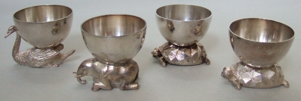 Appraisal: Silver comprising two egg cups raised on tortoise supports one