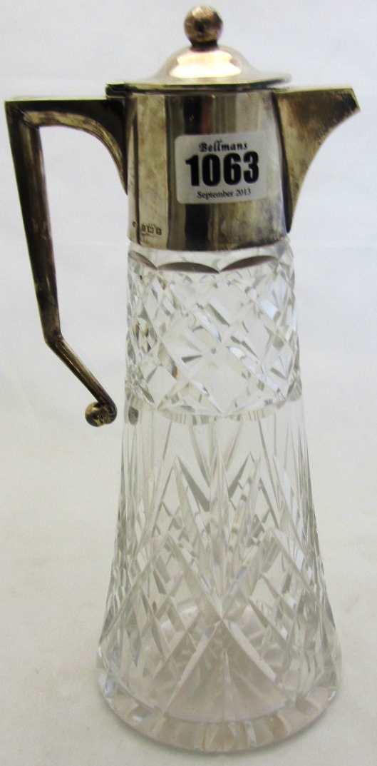 Appraisal: A silver mounted faceted glass claret jug with an angular