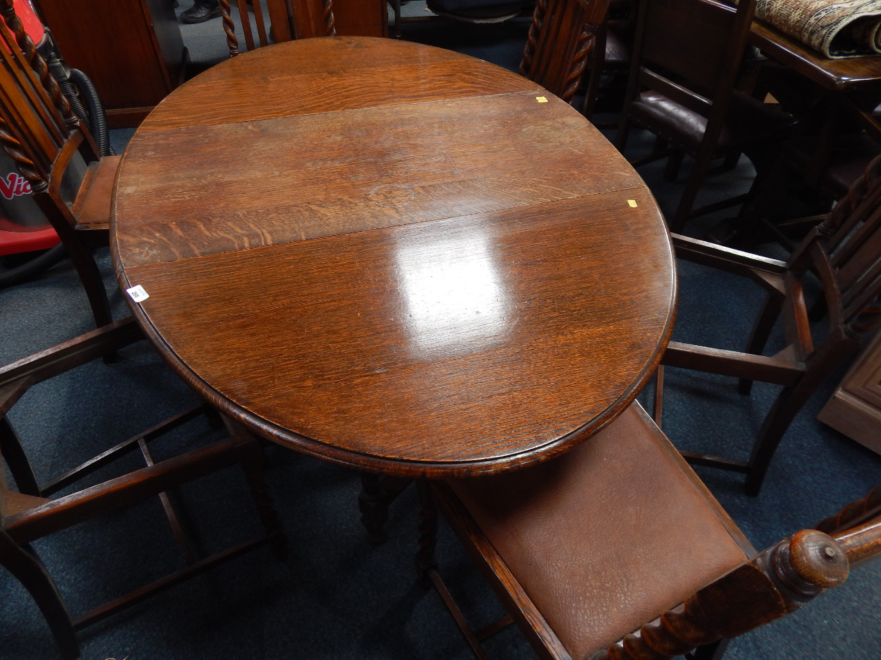 Appraisal: A mid thC oak barleytwist dropleaf table with six matching