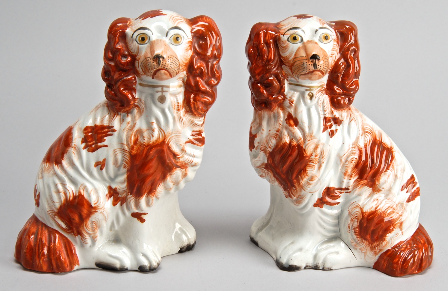 Appraisal: PAIR OF TH CENTURY ENGLISH STAFFORDSHIRE SPANIELS in rust and