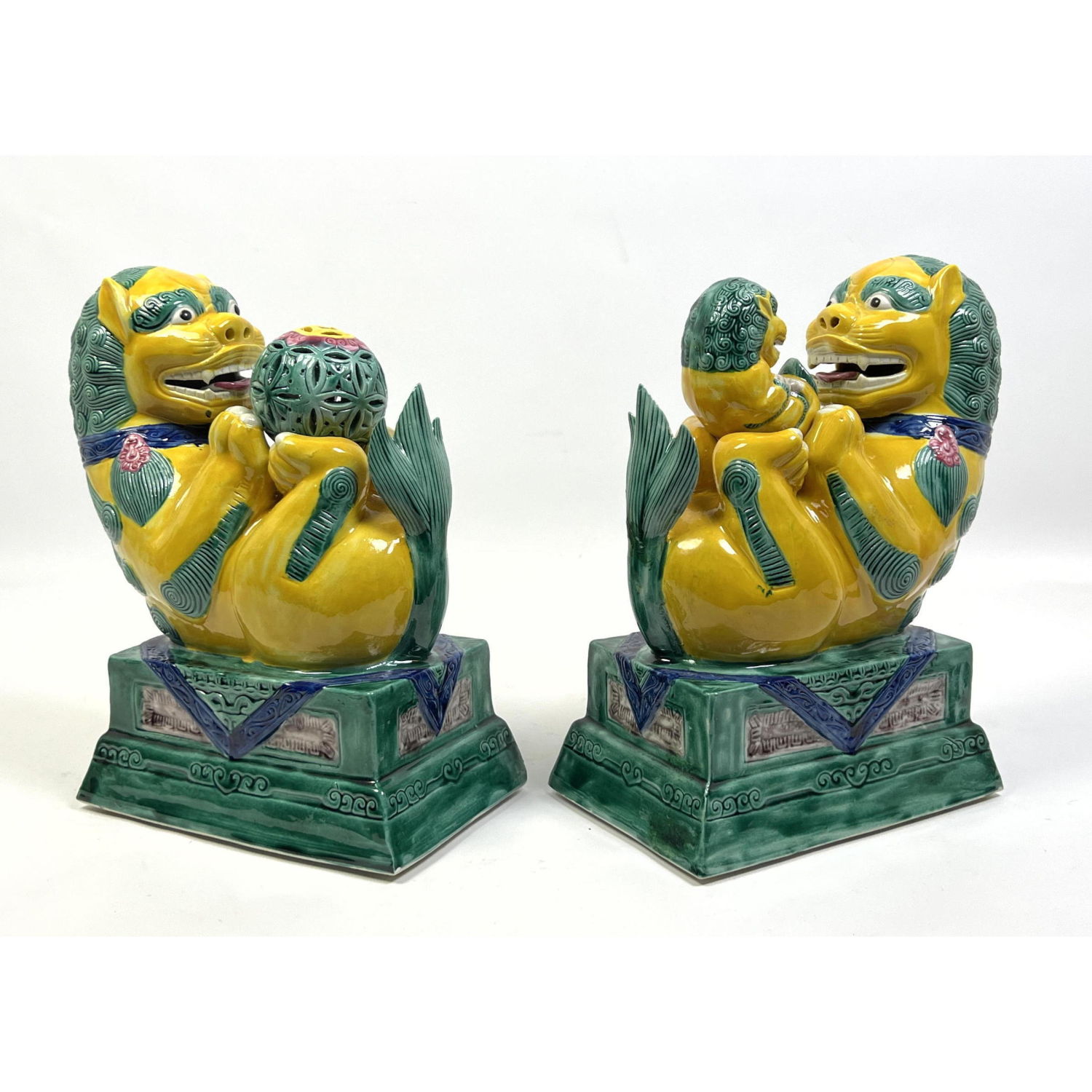 Appraisal: Pr Polychrome Glazed Ceramic Figural Lions One lion holds ball