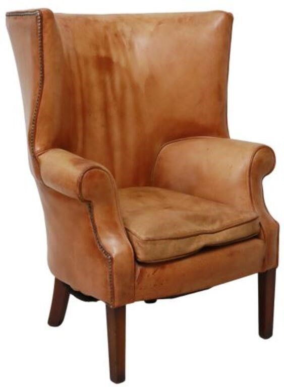 Appraisal: Georgian style wingback chair th c having wide barrel wingback