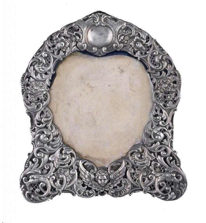 Appraisal: A VICTORIAN PHOTOGRAPH FRAME with heart shaped aperture the embossed