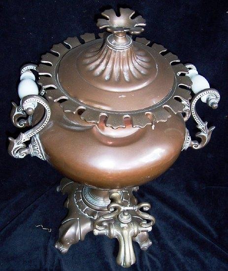 Appraisal: A Victorian copper samovar of circular shape with twin opaque