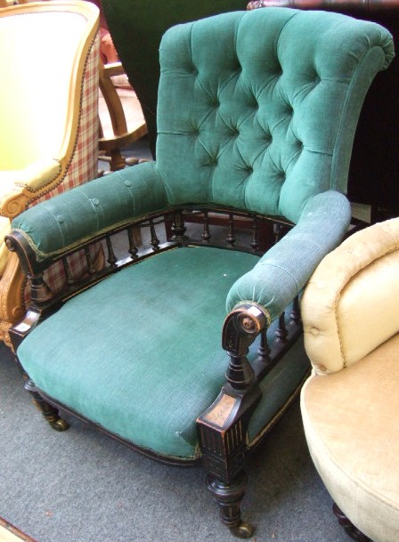 Appraisal: A Victorian button back open armchair the outswept arms with