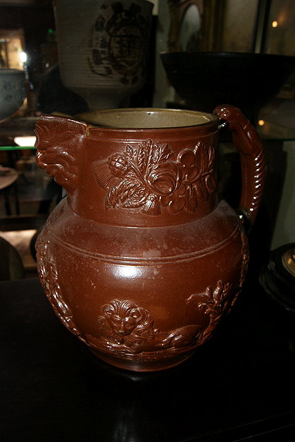 Appraisal: A LARGE TH CENTURY TREACLE GLAZED STONEWARE FLAGON with coat