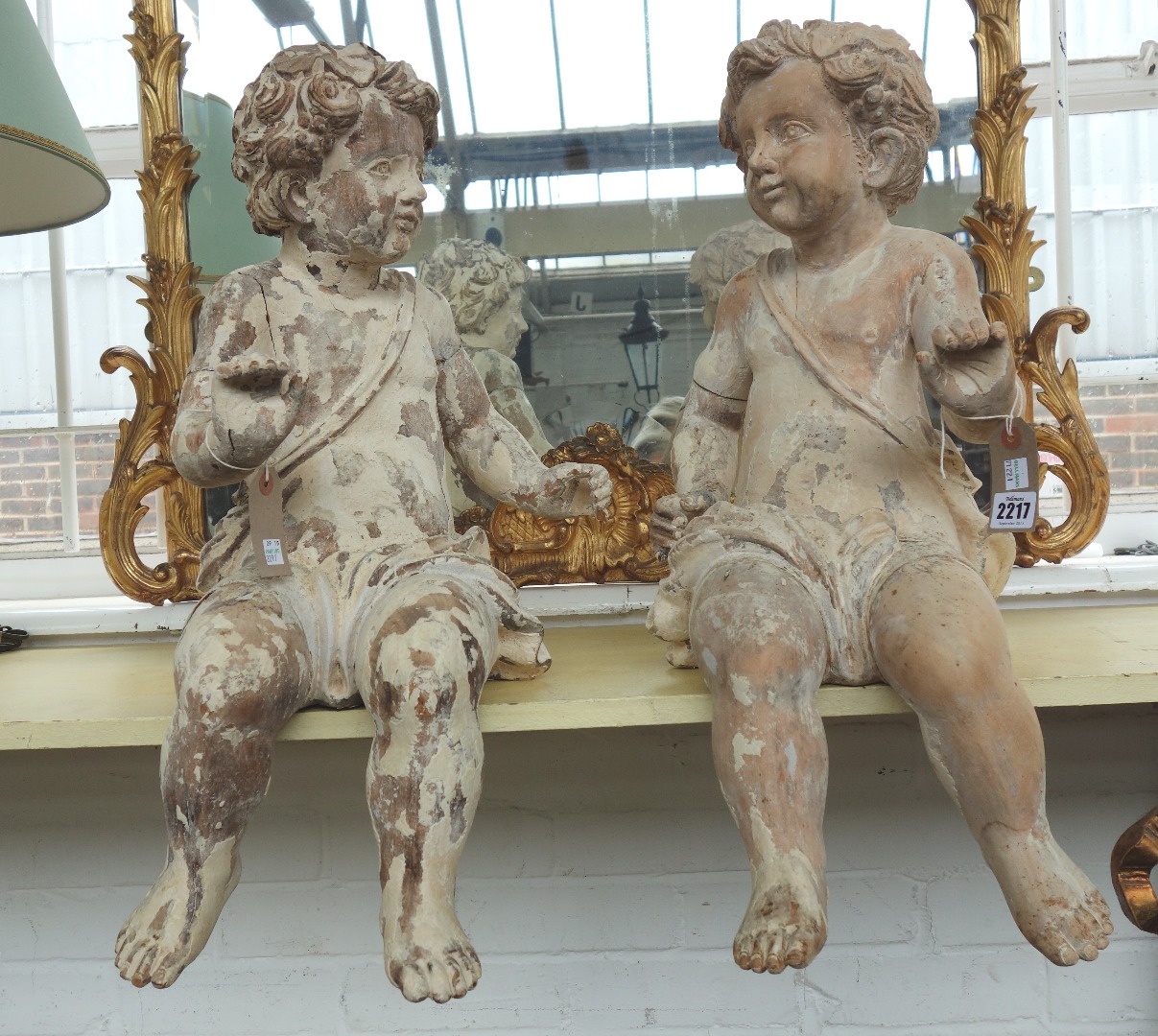 Appraisal: A pair of softwood and gesso cherubic figures late th