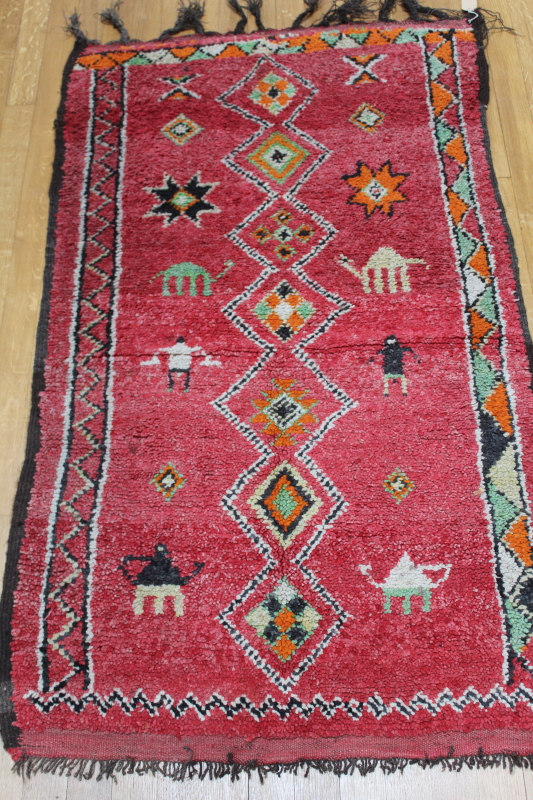 Appraisal: A Turkey pink ground rug decorated with camels and figures