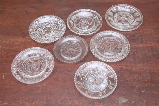 Appraisal: SEVEN LACY GLASS CUP PLATES Includes two eagles a butterfly