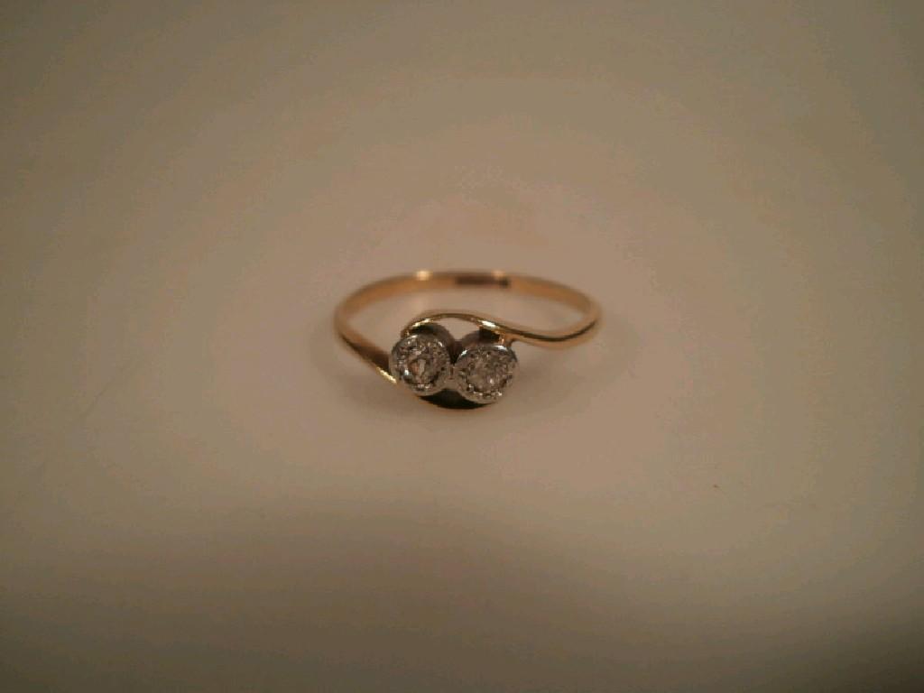 Appraisal: An oblique twist dress ring set with two diamonds total