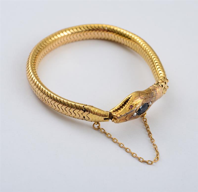 Appraisal: K GOLD SNAKE BRACELET The head set with a sapphire